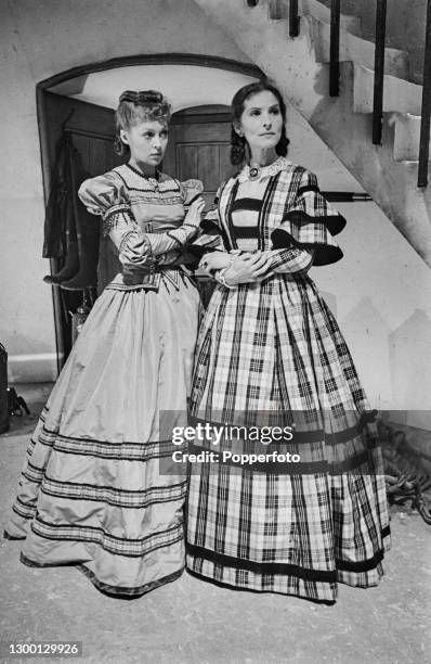 Actresses Lilli Palmer , on left, and Sybille Binder stand together in costume on set to play the roles of Melanie Kurtz and Anne-Marie Kurtz in the...