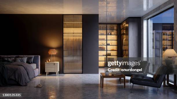 luxurious bedroom interior at nigh with messy bed, leather armchairs, closet and garden view from the window. - hotel closet stock pictures, royalty-free photos & images