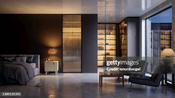 luxurious bedroom interior at nigh with messy bed, leather armchairs, closet and garden view from the window. - fabulous stock pictures, royalty-free photos & images