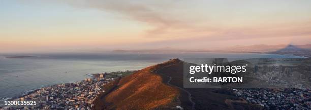 view of signal hill, cape town and robben island at sunset - signal hill cape town stock pictures, royalty-free photos & images