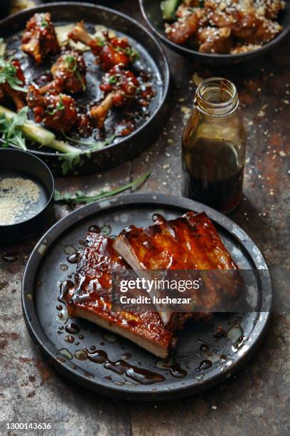 bbq lollipop chicken wings and spicy glazed pork ribs - smoked bbq ribs stock pictures, royalty-free photos & images