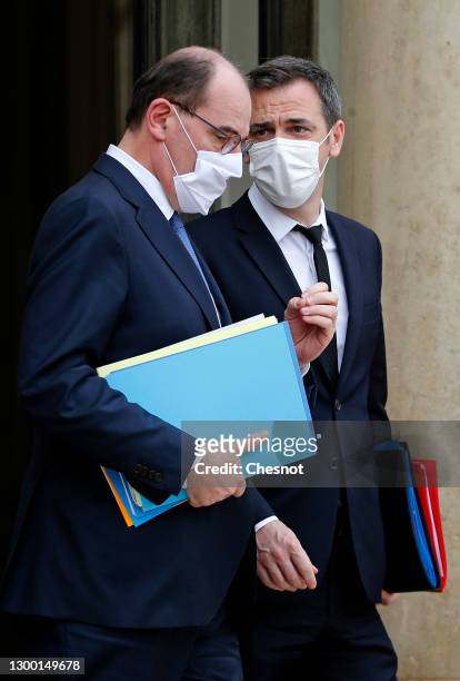 French Prime Minister Jean Castex and French Health Minister Olivier Veran wearing protective face masks, leave the Elysee Palace after the weekly...