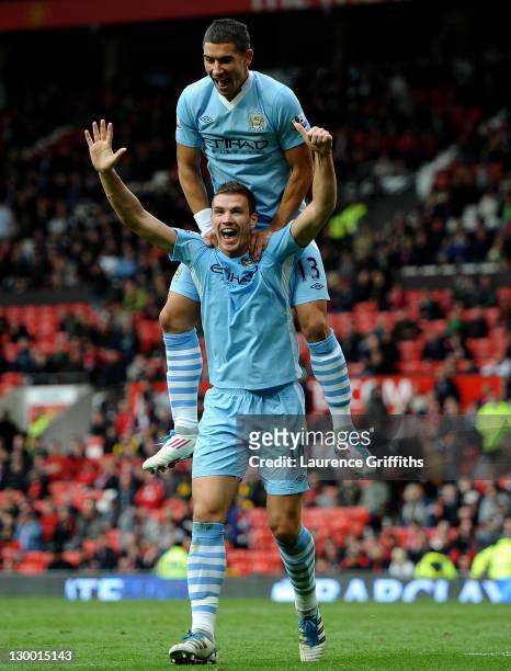 Edin Dzeko of Manchester City celebrates scoring his team's sixth goal with team mate Aleksandar Kolarov during the Barclays Premier League match...