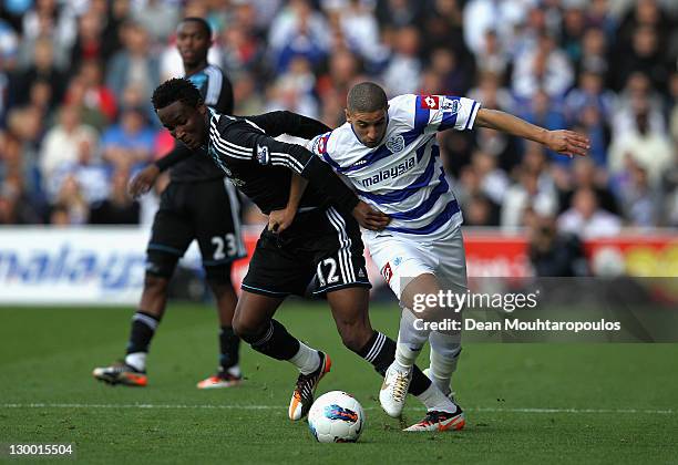 Jon Obi Mikel of Chelsea and Adel Taarabt of Queens Park Rangers battle for the ball during the Barclays Premier League match between Queens Park...