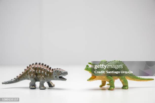 close-up of triceratops and euoplocephalus fighting - figurine stock pictures, royalty-free photos & images