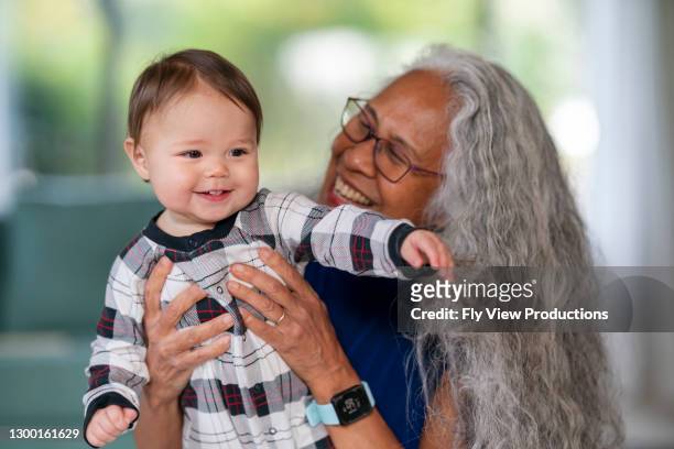 happy baby playing with her grandma - nanny stock pictures, royalty-free photos & images