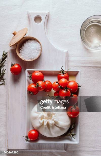 appetizer with fresh burrata cheese, cherry tomatoes, top view - mozzarella stock-fotos und bilder