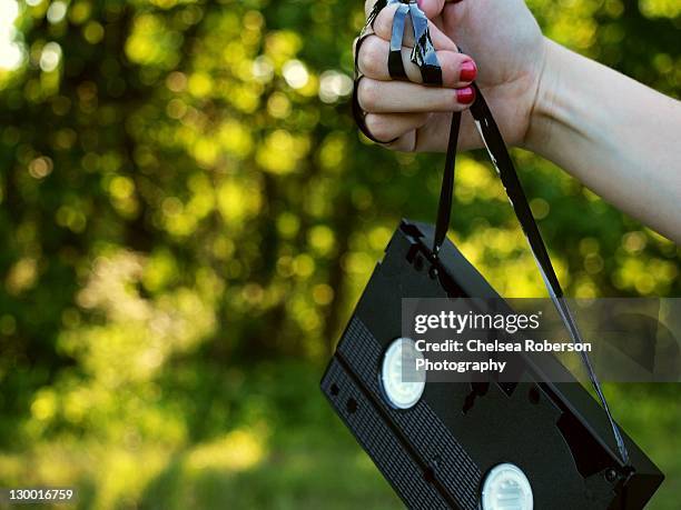 woman holding videotape - roberson stock pictures, royalty-free photos & images