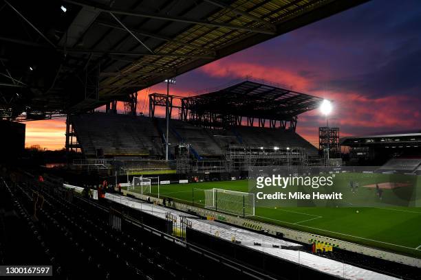 General view inside the stadium as the sun sets and the under construction new stand is seen prior to the Premier League match between Fulham and...