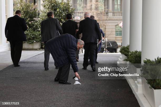 Senate Majority Leader Charles Schumer picks up dropped tissues outside the West Wing after he and fellow Democratic senators met with U.S. President...