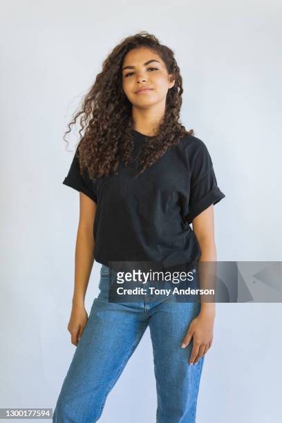 portrait of young woman on white background - t shirt stock pictures, royalty-free photos & images