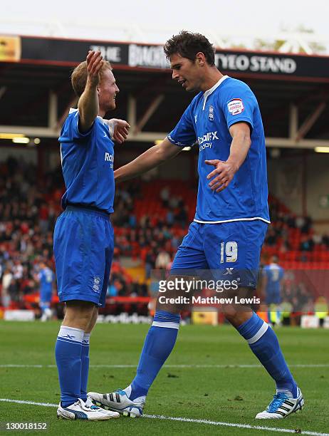 Chris Burke of Birmingham celebrates his second goal with team mate Nicola Zigic during the npower Championship match between Bristol City and...