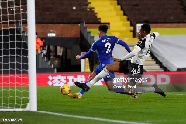 James Justin of Leicester City scores their side's second goal whilst under pressure from Tosin Adarabioyo of Fulham during the Premier League match...