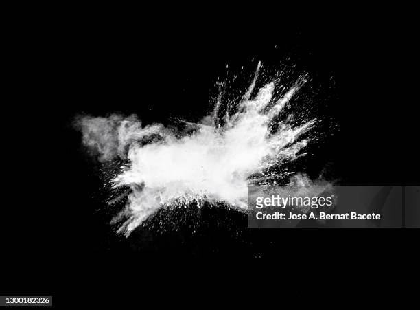 explosion by an impact of a cloud of particles of powder and smoke of white color on a black background. - powder stock-fotos und bilder