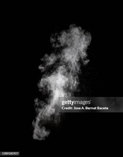 explosion by an impact of a cloud of particles of  smoke of white color on a black background. - zwarte achtergrond stockfoto's en -beelden