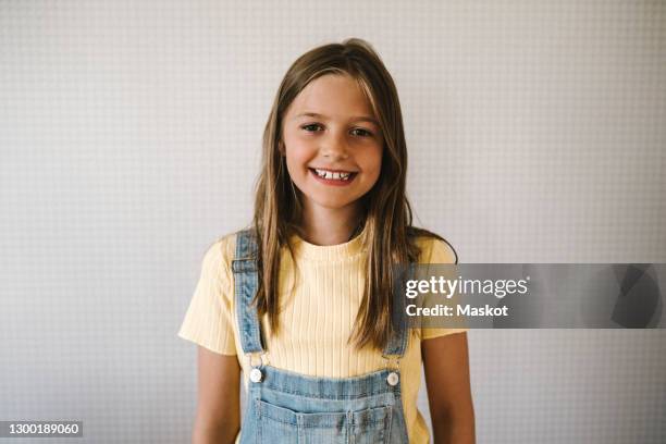 smiling girl against white wall at home - 11 fotografías e imágenes de stock