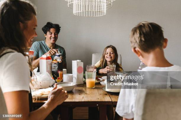 happy family having breakfast on dining table at home - café da manhã - fotografias e filmes do acervo