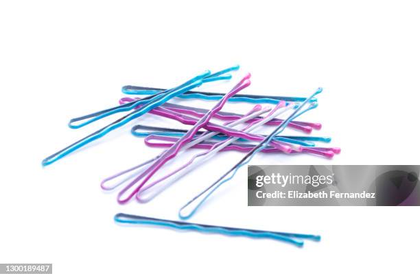 blue and pink bobby pins on white background - hairpin curve stock pictures, royalty-free photos & images