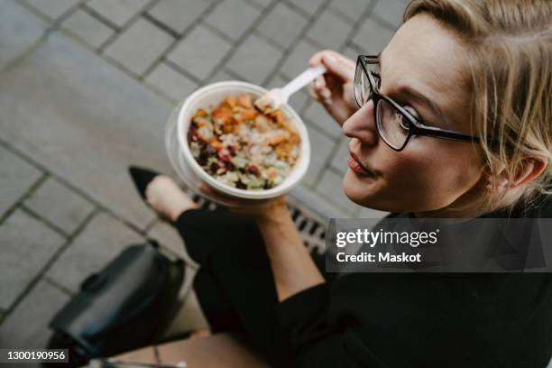 female entrepreneur with salad bowl looking away - business lunch outside stock pictures, royalty-free photos & images