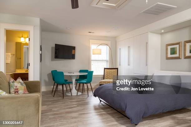 apartment with murphy bed in built in storage unit - murphy bed stock pictures, royalty-free photos & images