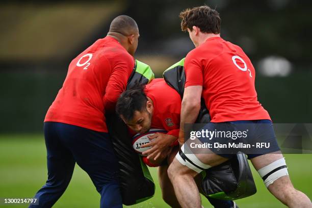 Billy Vunipola of England takes on Kyle Sinckler and Tom Curry of England during an England training session at The Lensbury on February 03, 2021 in...