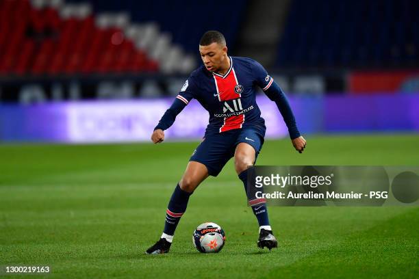 Kylian Mbappe of Paris Saint-Germain runs with the ball during the Ligue 1 soccer match between Paris Saint-Germain and Nimes Olympique at Parc des...