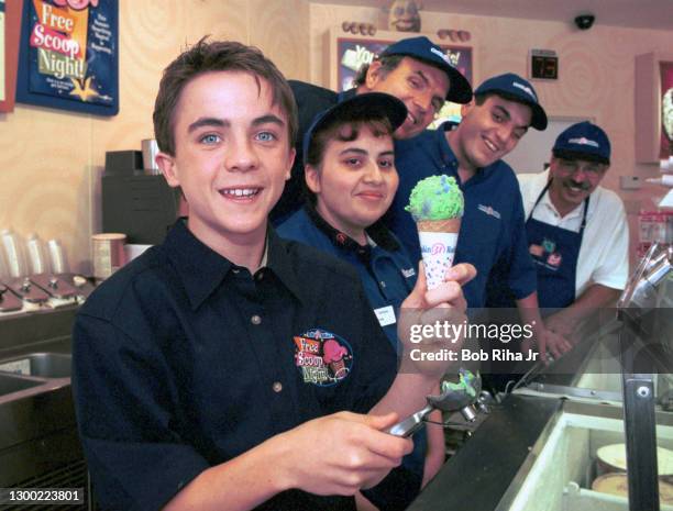 Frankie Muniz, star of the hit television series "Malcolm in the Middle" perfects his scooping skills inside Baskin-Robbins in preparation for...