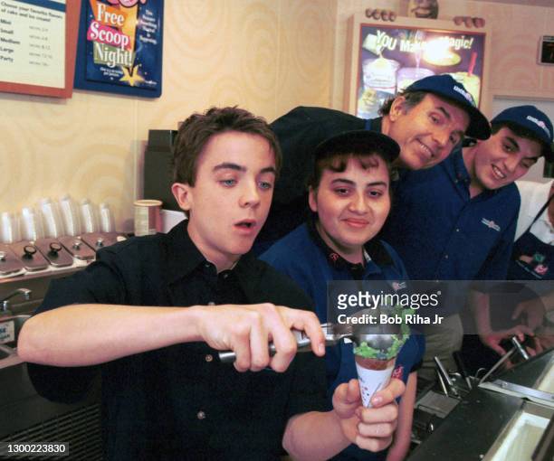 Frankie Muniz, star of the hit television series "Malcolm in the Middle" perfects his scooping skills inside Baskin-Robbins in preparation for...