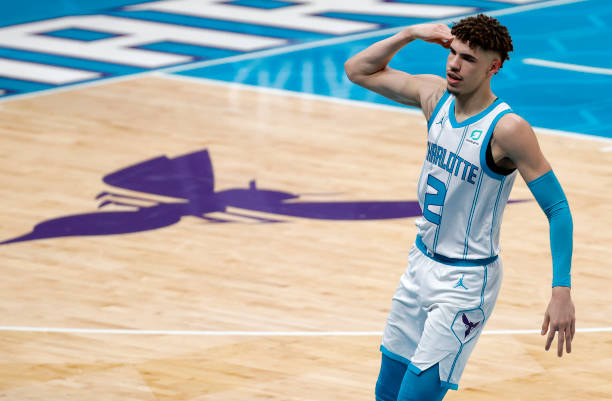 LaMelo Ball of the Charlotte Hornets reacts following a three point basket during the first quarter of their game against the Philadelphia 76ers at...