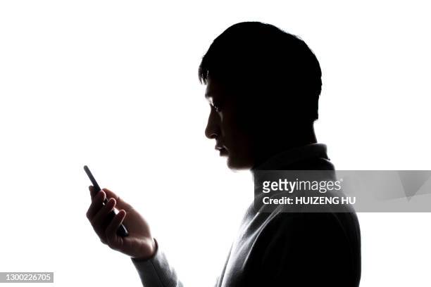 male portrait silhouette, using mobile phone - phone side view stock pictures, royalty-free photos & images