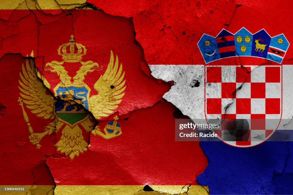 Flags of Montenegro and Croatia painted on cracked wall