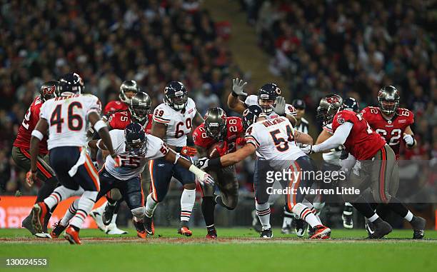 Kregg Lumpkin of the Tampa Bay Buccaneers attempts to break through the Chicago Bears defense during the NFL International Series match between...