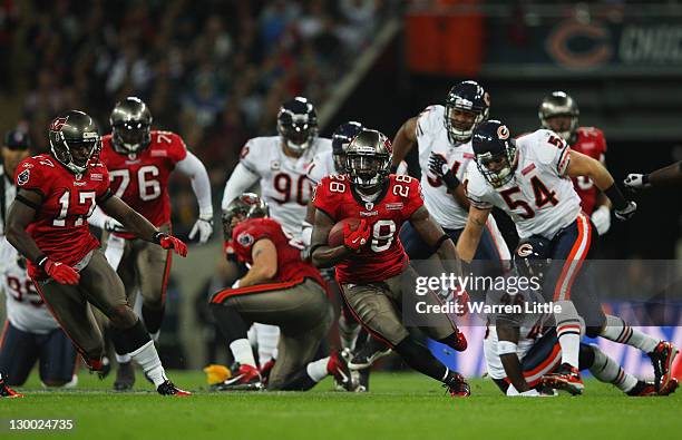 Kregg Lumpkin of the Tampa Bay Buccaneers attempts to break through the Chicago Bears defense during the NFL International Series match between...