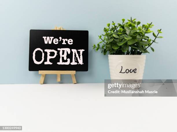 we're open sign on black board with potted plant. malaysia, advice, backgrounds, banner - sign, black color - store opening covid stock pictures, royalty-free photos & images
