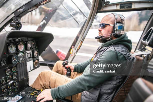pilot inside a helicopter cockpit. preflight check. - beard pilot stock pictures, royalty-free photos & images