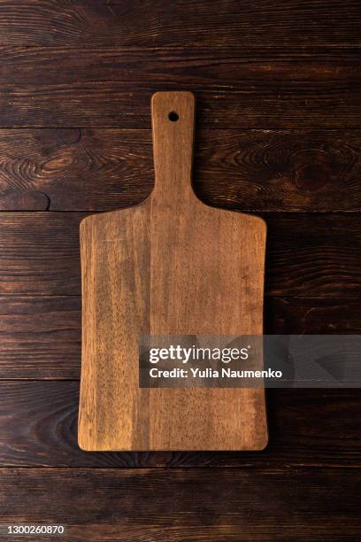 cutting board on dark wooden table. - chopping board from above stock pictures, royalty-free photos & images