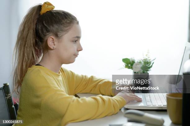 teenager girl, 10-12 years old studying at home remotely during quarantine - 10 11 years stock pictures, royalty-free photos & images