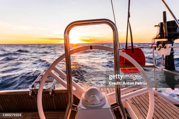 steering wheel on the yacht at sunset. yachting, luxury vacation at sea - rudder stock pictures, royalty-free photos & images