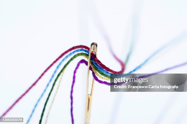 needle of sewing and colored threads - multiple threads stock pictures, royalty-free photos & images