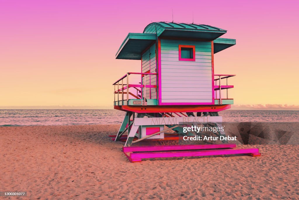 Dreamlike picture of colorful lifeguard cabin in the Miami beach at sunset.