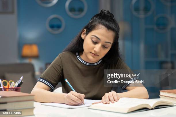 teenager girl studying at home - stock photo - school book stock pictures, royalty-free photos & images