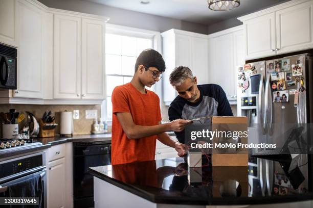 father and son working on school science project - school science project stock pictures, royalty-free photos & images