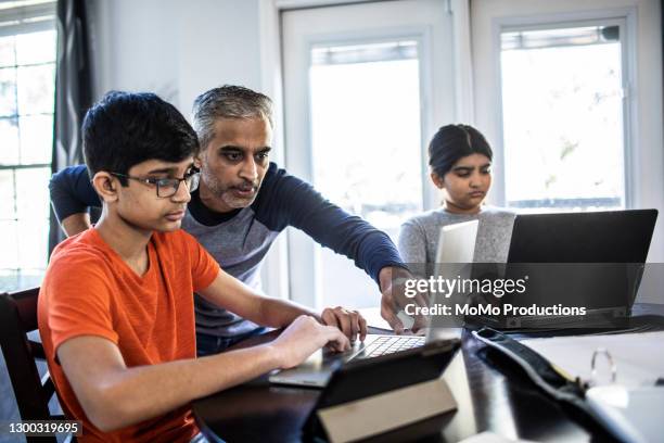father helping high school students with schoolwork - dad homework stock pictures, royalty-free photos & images