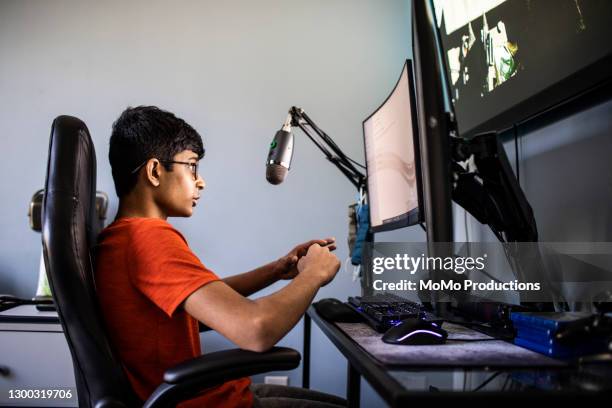 high school boy online gaming at home - teenage boy playing playstation stock pictures, royalty-free photos & images