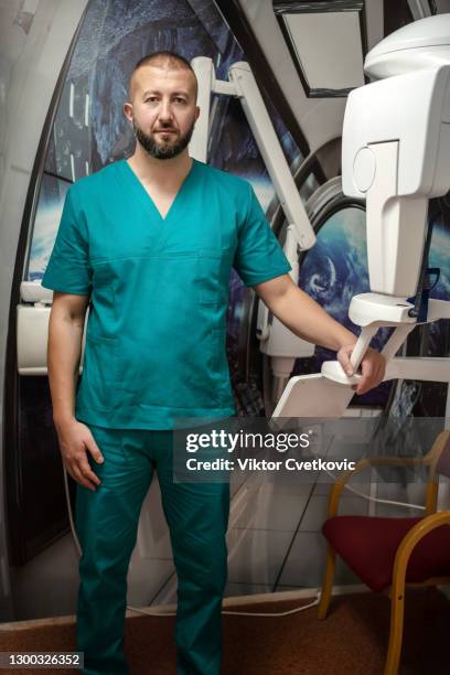 a mid adult male dentist - radiographer stock pictures, royalty-free photos & images