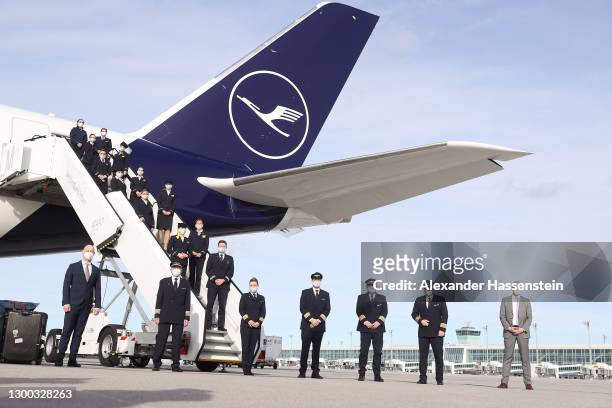 Crewmembers pose after Lufthansa flight number LH2575 returns from the company's longest direct flight ever after having travelled 13,592km in 15...