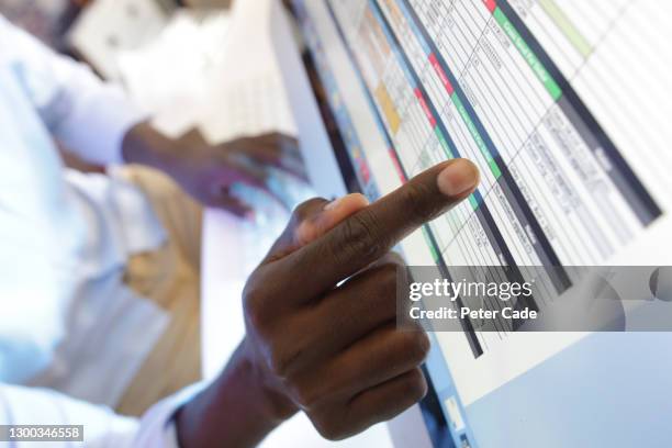 pointing at data on computer screen - health records stock pictures, royalty-free photos & images