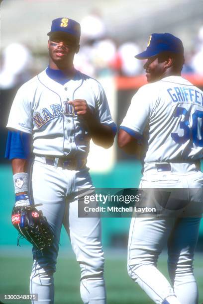 Ken Griffey Sr and Ken Griffey Jr. #24 of the Seattle Mariners talk before a baseball game against the Baltimore Orioles on September 5, 1990 at...