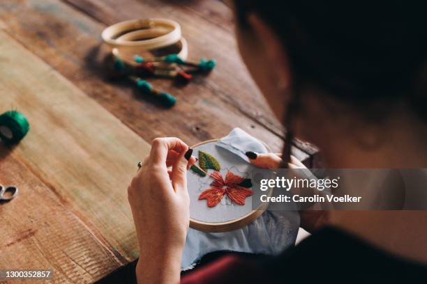 view over shoulder of a woman doing embroidery and colourful needlework - handicraft stock pictures, royalty-free photos & images