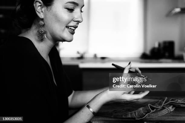 young woman gesturing with hands while holding a pen - mexico black and white stock pictures, royalty-free photos & images